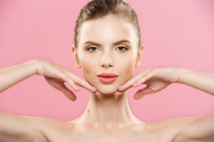 Beauty Concept - Close up Portrait of attractive caucasian girl with beauty natural skin isolated on pink background with copy space.